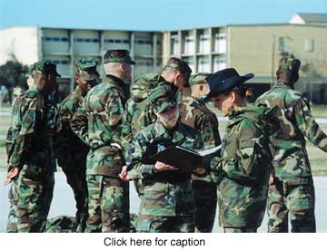 Photo of instructor preparing a student to align troops.